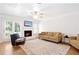 Cozy living room with fireplace, plush seating, and hardwood floors at 306 Autumn Leaf Way, Norcross, GA 30093