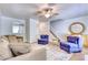 Open-concept living room with plush seating and staircase at 306 Autumn Leaf Way, Norcross, GA 30093