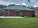 Brick house backyard featuring lush green grass, a patio area, and well-maintained landscaping at 3473 Newtons Crest Cir, Snellville, GA 30078