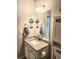 Granite countertop, decorative mirrors and lighting create a charming bathroom space at 3473 Newtons Crest Cir, Snellville, GA 30078
