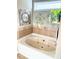 Relaxing soaking tub with tile surround and decorative accents at 3473 Newtons Crest Cir, Snellville, GA 30078