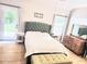 Comfortable bedroom with lots of natural light, wood floors, and walk-out to patio at 3473 Newtons Crest Cir, Snellville, GA 30078