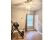 Bright bedroom features hardwood floors, a ceiling fan, and natural light from a large window at 3473 Newtons Crest Cir, Snellville, GA 30078