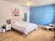 A bedroom featuring a blue decorative wall, a modern bed, and a large window at 3473 Newtons Crest Cir, Snellville, GA 30078