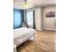 Bright bedroom with stylish blue accent wall and light wood flooring at 3473 Newtons Crest Cir, Snellville, GA 30078