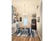 Bright dining room features stylish decor, hardwood floors, and a charming chandelier at 3473 Newtons Crest Cir, Snellville, GA 30078