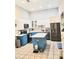 Well-lit kitchen boasts stainless steel appliances, blue and white cabinets, and a functional island at 3473 Newtons Crest Cir, Snellville, GA 30078