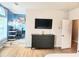 Open-concept living area with a large TV, hardwood floors, and a view to the home office space at 3473 Newtons Crest Cir, Snellville, GA 30078