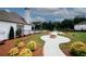Expansive backyard with lush greenery, a stone fire pit, and a curved walkway leading to a pool and play area at 3579 Silvery Way, Powder Springs, GA 30127