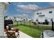 View of the fenced backyard with grill and patio seating area at 3579 Silvery Way, Powder Springs, GA 30127