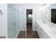 Bathroom featuring a glass-enclosed shower, a double sink vanity, and a view into the bedroom at 3579 Silvery Way, Powder Springs, GA 30127
