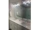 Bathroom featuring a double vanity with white countertops, a large mirror and a glass shower at 3579 Silvery Way, Powder Springs, GA 30127