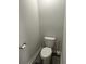 Small half bathroom with a toilet, toilet paper holder, and base trim at 3579 Silvery Way, Powder Springs, GA 30127
