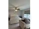 Comfortable bedroom with a queen-size bed, ceiling fan, and seating area at 3579 Silvery Way, Powder Springs, GA 30127