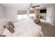 Large bedroom with windows, a ceiling fan, a TV, a couch, and a comfortable bed with decorative pillows at 3579 Silvery Way, Powder Springs, GA 30127