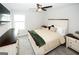 Cozy bedroom features a ceiling fan, window, and dark wood dresser at 3579 Silvery Way, Powder Springs, GA 30127