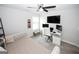 Bright bedroom with a ceiling fan, window, desk and cushioned bench at 3579 Silvery Way, Powder Springs, GA 30127