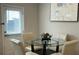 Cozy dining area with a glass table, seating for four, and a view of the yard at 3579 Silvery Way, Powder Springs, GA 30127