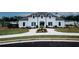 Elegant white brick home featuring a well-manicured lawn, symmetrical landscaping, and a charming entryway at 3579 Silvery Way, Powder Springs, GA 30127