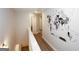 Upstairs hallway featuring an interesting world map art piece, wooden floors, and white trim at 3579 Silvery Way, Powder Springs, GA 30127