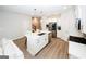 Bright, all-white kitchen featuring stainless steel appliances, an island with pendant lights, and sleek countertops at 3579 Silvery Way, Powder Springs, GA 30127
