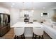 Bright kitchen with white cabinetry, stainless steel appliances, a central island, and seamless flow into the living space at 3579 Silvery Way, Powder Springs, GA 30127
