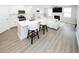 Contemporary kitchen with island seating, flowing into living room with fireplace, perfect for modern living at 3579 Silvery Way, Powder Springs, GA 30127