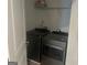 Laundry room view showing stainless steel washer and dryer and wire shelving at 3579 Silvery Way, Powder Springs, GA 30127