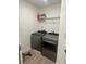 Laundry room with front-load washer and dryer, white walls, and overhead wire shelving at 3579 Silvery Way, Powder Springs, GA 30127
