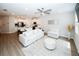 Open-concept living space with hardwood floors, a ceiling fan, and a kitchen featuring stainless steel appliances at 3579 Silvery Way, Powder Springs, GA 30127