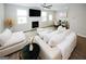 Cozy living room with a fireplace, a ceiling fan, ample seating, and a dining area in the background at 3579 Silvery Way, Powder Springs, GA 30127