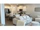 Open concept living room and kitchen with an island, stainless steel appliances, and hardwood floors at 3579 Silvery Way, Powder Springs, GA 30127