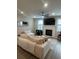 Comfortable living room featuring a plush sofa, fireplace, large TV, ceiling fan and an abundance of natural light at 3579 Silvery Way, Powder Springs, GA 30127