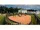 Community playground with green and brown play structure atop wood mulch, surrounded by a dark wooden fence at 3579 Silvery Way, Powder Springs, GA 30127