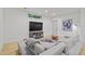 Cozy basement featuring a gray sofa, entertainment unit, and natural light from the window at 1433 Wessyngton Ne Rd, Atlanta, GA 30306
