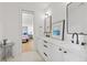 Bathroom with dual vanities featuring black hardware and a view to the adjacent bedroom at 1433 Wessyngton Ne Rd, Atlanta, GA 30306