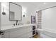 Modern bathroom featuring a white vanity, black fixtures, and a shower-tub combination at 1433 Wessyngton Ne Rd, Atlanta, GA 30306