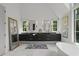 Bathroom boasts dual vanities, soaking tub, black cabinets, gold hardware, and framed mirrors at 1433 Wessyngton Ne Rd, Atlanta, GA 30306