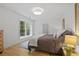 Bright bedroom with a large window, hardwood floors, and a comfortable bed with a nightstand at 1433 Wessyngton Ne Rd, Atlanta, GA 30306
