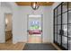 Bright foyer with wood floors, archways and a modern front door with steel and glass at 1433 Wessyngton Ne Rd, Atlanta, GA 30306