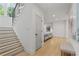 Hallway with hardwood floors, modern staircase, and a glimpse into the adjacent living area at 1433 Wessyngton Ne Rd, Atlanta, GA 30306