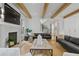 Living room features wooden beams, fireplace, and modern furniture at 1433 Wessyngton Ne Rd, Atlanta, GA 30306