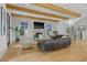 Bright living room features wooden beams, fireplace, and modern staircase at 1433 Wessyngton Ne Rd, Atlanta, GA 30306