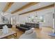 Open-concept living room with wood beams and modern furnishings at 1433 Wessyngton Ne Rd, Atlanta, GA 30306