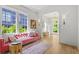 Bright living room with oversized windows, wood floors and a pink sofa at 1433 Wessyngton Ne Rd, Atlanta, GA 30306