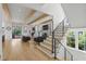 Open-concept living room with hardwood floors, wooden beams, and modern staircase at 1433 Wessyngton Ne Rd, Atlanta, GA 30306