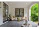 Covered patio with stone tile flooring and comfortable wicker seating at 1433 Wessyngton Ne Rd, Atlanta, GA 30306