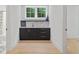 Wet bar featuring dark cabinets, marble countertop, gold hardware, and refrigerator at 1433 Wessyngton Ne Rd, Atlanta, GA 30306