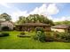 Spacious backyard featuring a lush lawn, various plants, and a partial fence at 1472 High Meadow Dr, Stone Mountain, GA 30083