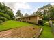 Exterior view showcasing the brick home, backyard, and green lawn at 1472 High Meadow Dr, Stone Mountain, GA 30083